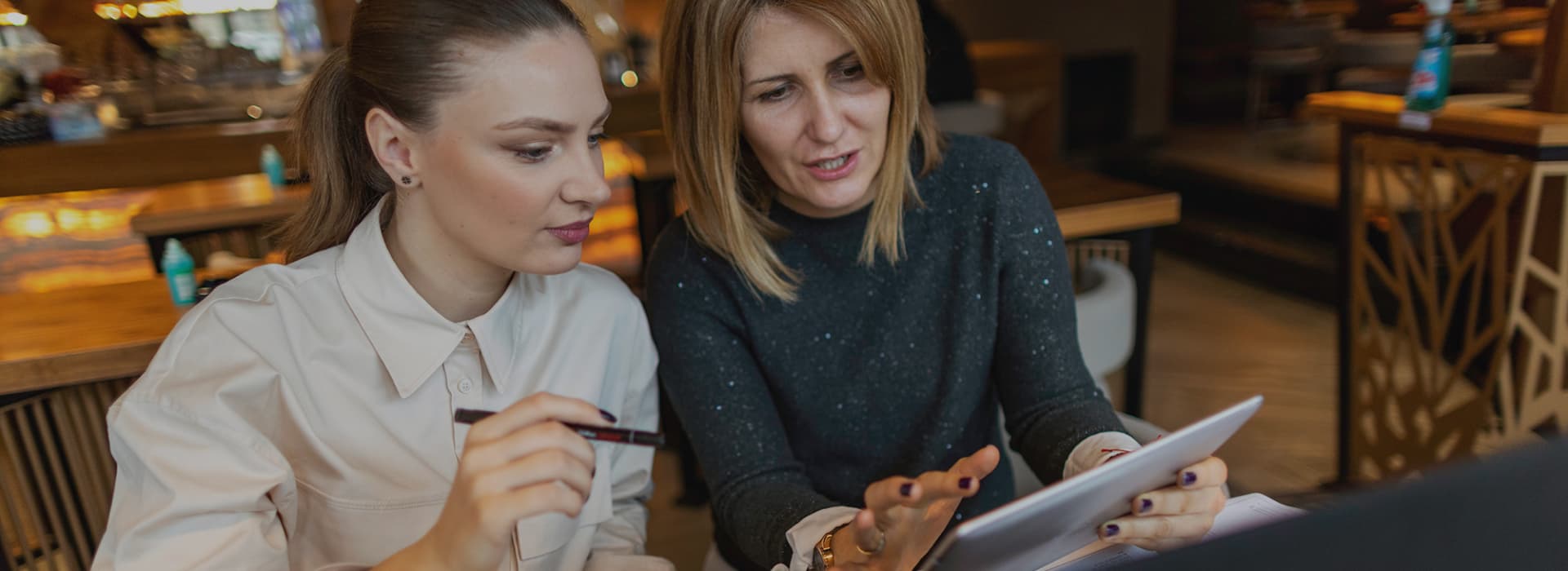 2 woman looking at pos