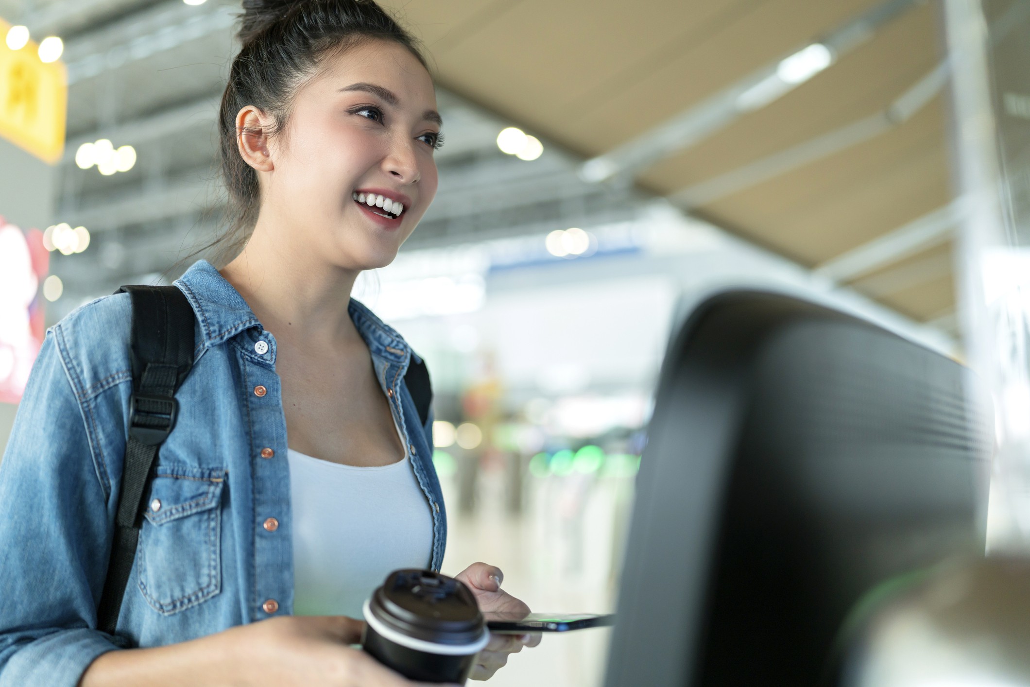 easy checking in asian female smiling hand using smart phone